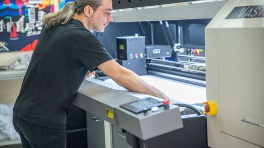 man working on a printer