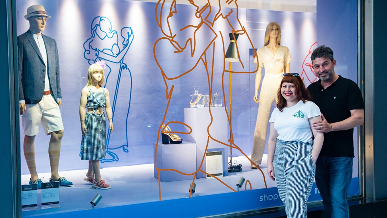 two people in front of a window