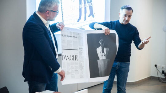 people holding a newspapper