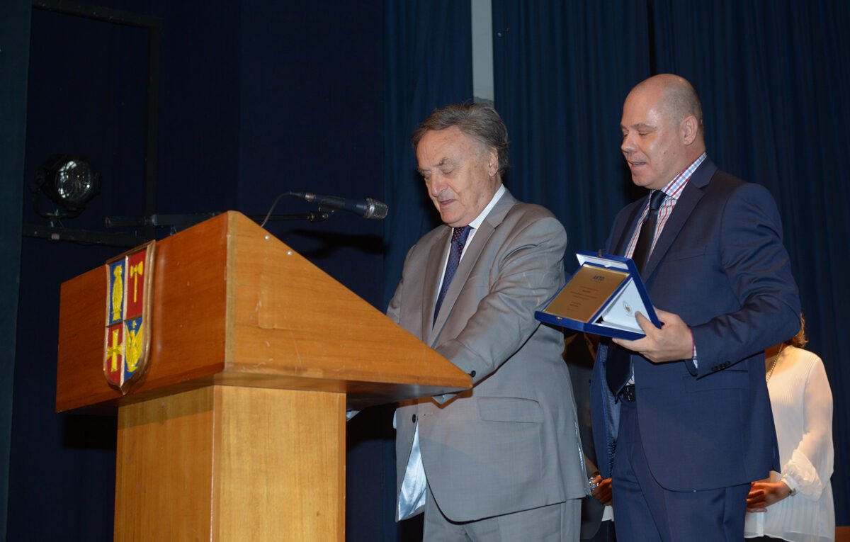 two people talking at a ceremony